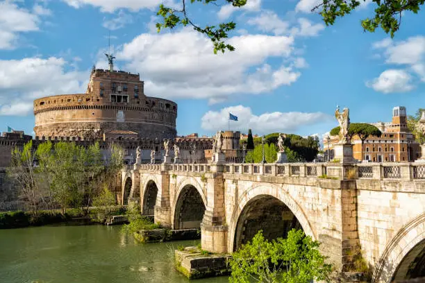Italy - April 24, 2023: Italy, Lazio, Rome. Castel Sant'Angelo or castle of Holy Angel and the Sant'Angelo bridge during sunny spring day in Rome.