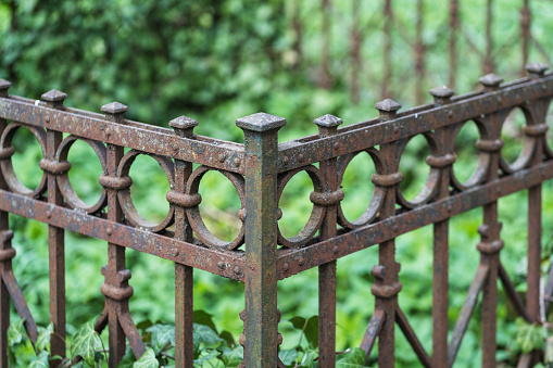 Close-up of an old cemetery fence