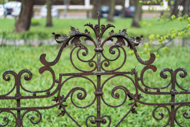 Craiova, Romania - December 21, 2024: Ornate wrought iron scrollwork on the gate of the Beaux Arts style Jean Mihail Palace museum entrance in Craiova showing decorative metal detail