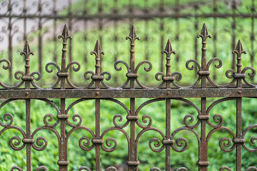 Close-up of an old cemetery fence