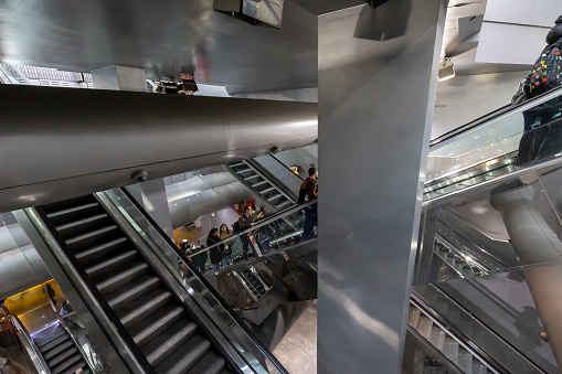 Naples, Italy - April 21, 2023: In the Garibaldi station of the Metro line 1 people enter and exit using the many escalators.