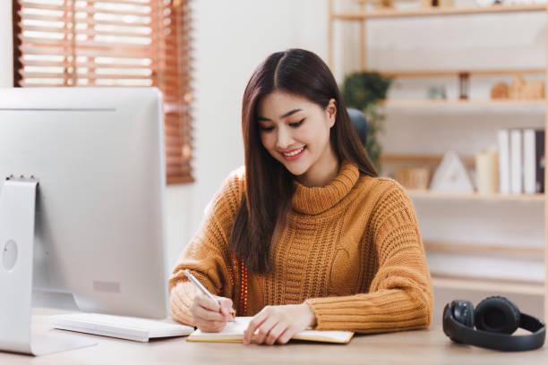 istock Attractive Asian woman resting comfortable living room and using desktop computer, Relax, Sofa, Lifestyle 1486883234
