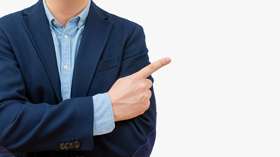 Cropped view of business man pointing right with index finger on light background. Success concept.