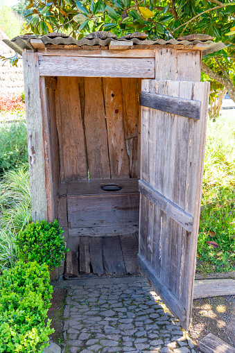 small wooden shack with toilet hole to defecate and urinate sitting down.