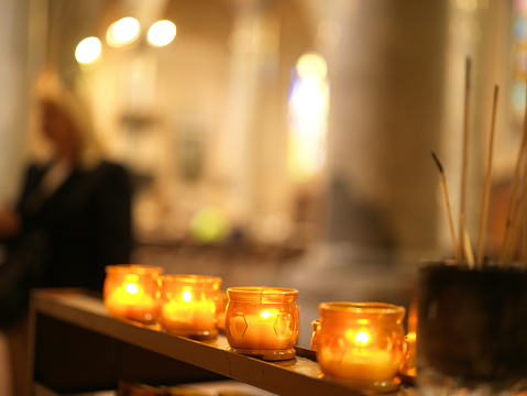 votive lights lit in church