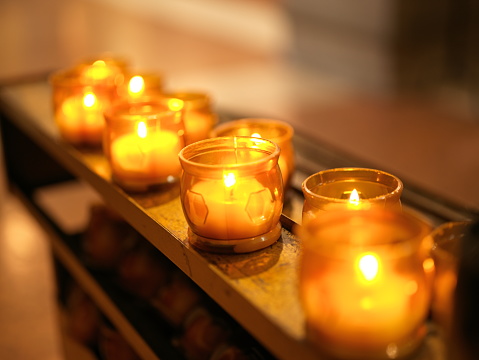 votive lights lit in church