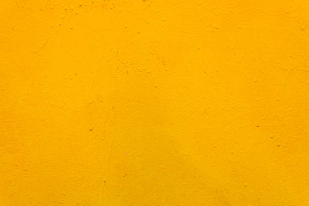 istock The metal surface is rough, with smudges, painted with yellow paint. Bright colored background. 1486891712