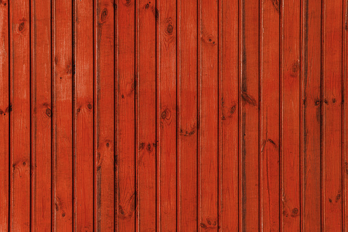 Red wooden background. Rough boards. Natural wood texture and pattern.