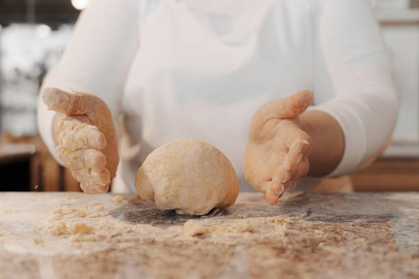 istock Crop cook kneading dough on counter 1486894578