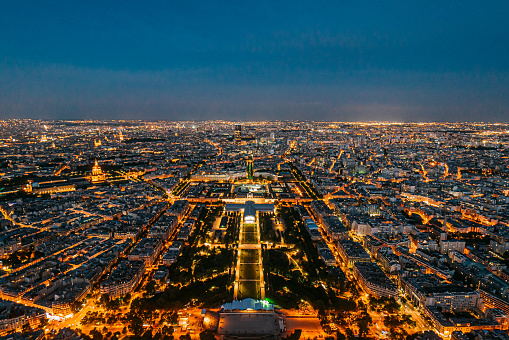 High Angle View from Eiffel Tower of an Illuminated Champ de Mars Park on a Summer Evening. Grand Palais Éphémère is centered at the southeast end of the park.