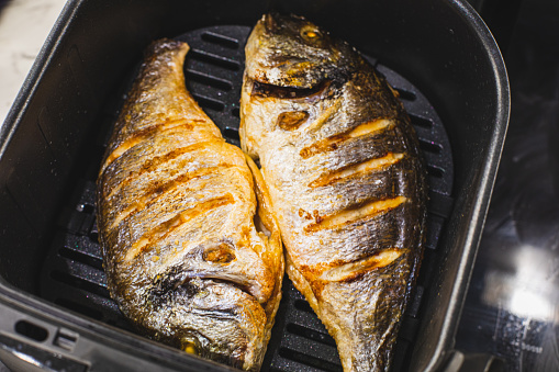 Two sea bream fish, prepared in an air grill
