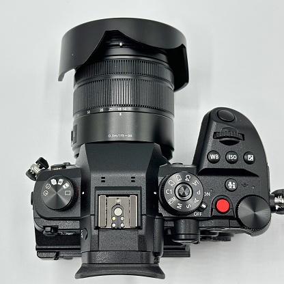 Black professional mirrorless camera on a white background