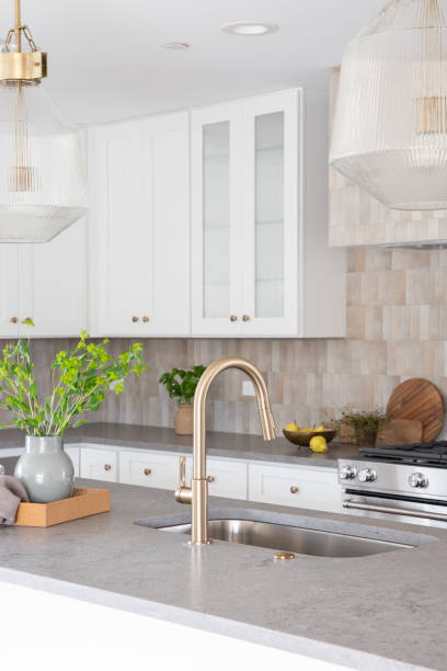 istock A gold kitchen faucet detail with cozy decorations. 1486899452