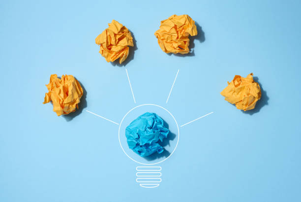 istock The concept of inspiration with new ideas, the search for creative solutions, crumpled sheets of paper in the form of balls on a blue background 1486899472