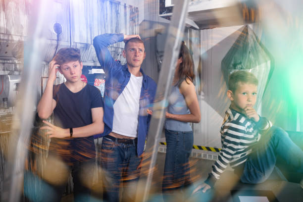 istock Brooding family tries to find a solution to a puzzle in a quest room 1486901785