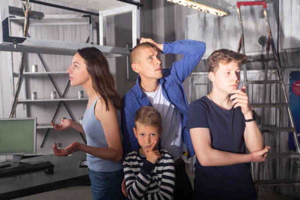 istock Brooding family tries to find a solution to a puzzle in a quest room 1486901927
