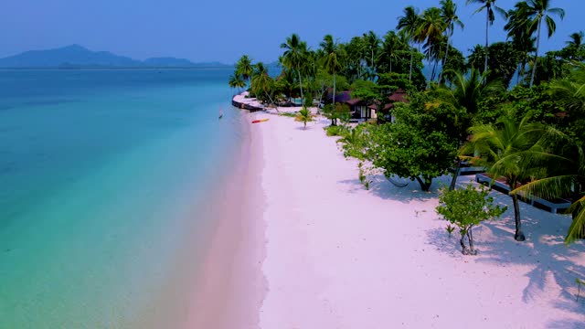 Koh Mook Island or Koh Muk Trat Thailand a tropical white beach with palm trees