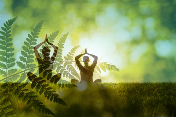 Double exposure of couple meditating in nature setting