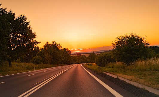 Photo of country highway road and a beautiful sunset