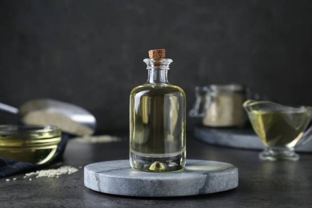istock Sesame oil in glass bottle on dark grey table 1486908946