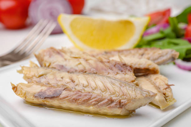 Delicious canned mackerel fillets served on table, closeup