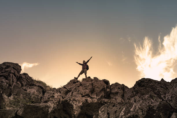 istock Reaching goals, man celebrating victory on a mountain top 1486909764
