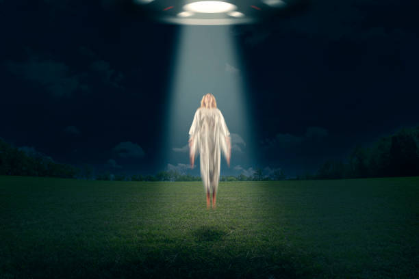 A conceptual image of a woman being abducted by an alien aircraft.