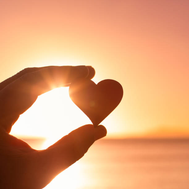 istock Heart against the ocean sunset sky, love symbol 1486910072