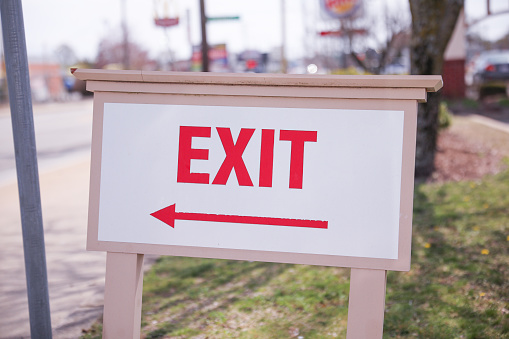 exit sign in red and white color signifies a way out or emergency exit. It is an essential safety feature in public and commercial buildings, providing clear and visible guidance to people