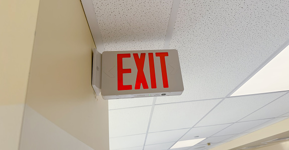 Close up photo of emergency exit door with exit sign