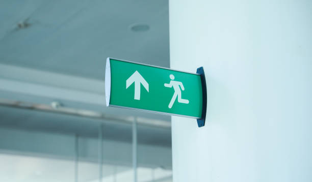 istock exit sign in red and white color signifies a way out or emergency exit. It is an essential safety feature in public and commercial buildings, providing clear and visible guidance to people 1486910224