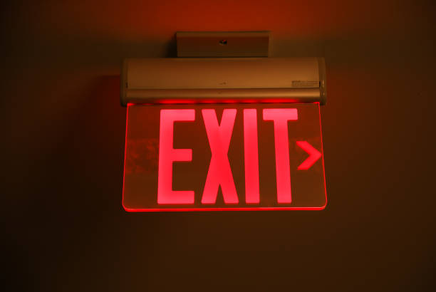 istock exit sign in red and white color signifies a way out or emergency exit. It is an essential safety feature in public and commercial buildings, providing clear and visible guidance to people 1486910264