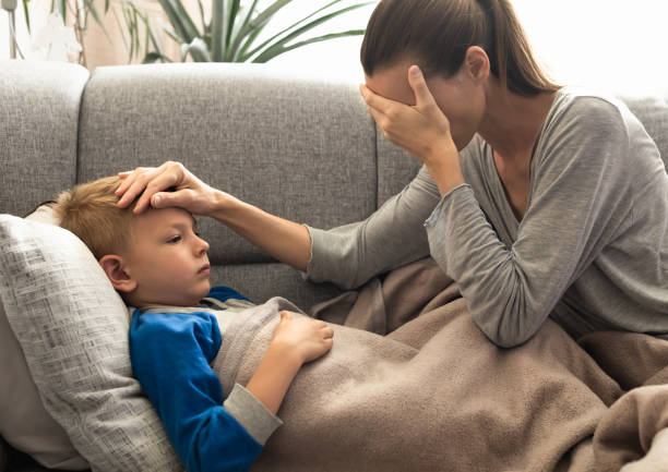 istock Worried mother with sick child 1486911349