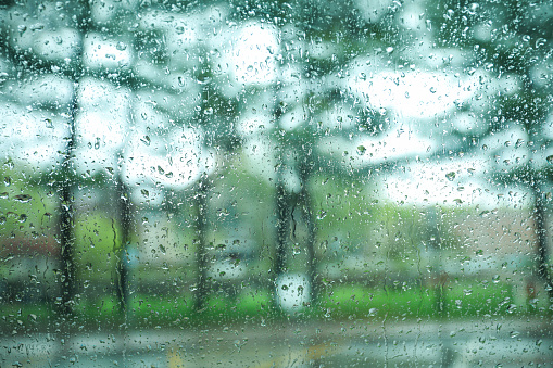 car window covered in raindrops symbolizes the beauty and tranquility of nature. The water droplets on the glass and the sound of rain on the roof create a calming ambiance