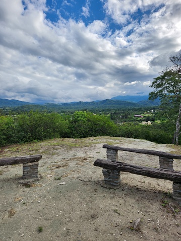 Two wooden plank benches in a beautiful landscape