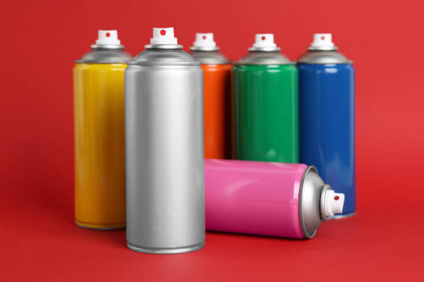 istock Colorful cans of spray paints on red background 1486926657