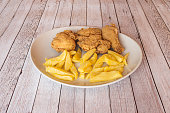 Kentucky-style breaded fried chicken garnished with homemade fries