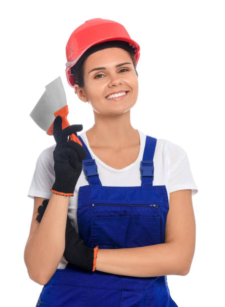 istock Professional worker with putty knives in hard hat on white background 1486933367