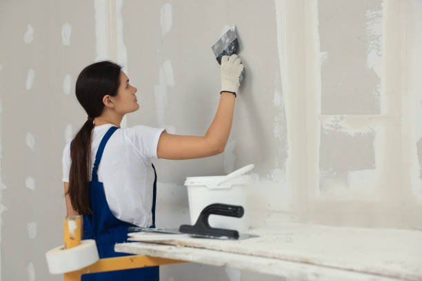 istock Worker plastering wall with putty knife indoors 1486933551