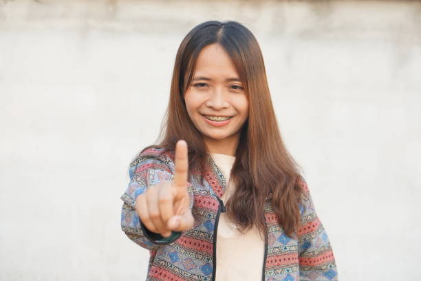 Asian woman pointing her finger
