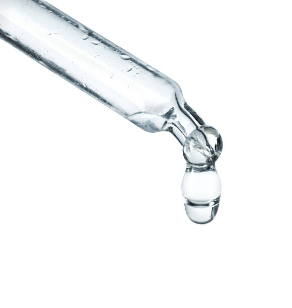 istock Cosmetic pipette with a dripping drop close-up on a white background 1486942286