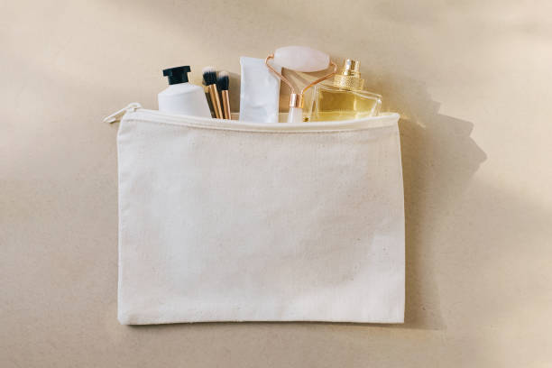 istock Canvas bag with cosmetics and accessories on beige background. 1486942468