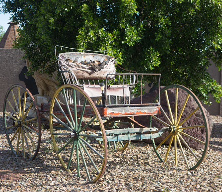 Buggy with run down weathered top set in open space for a colorful nostalgic display of days long gone