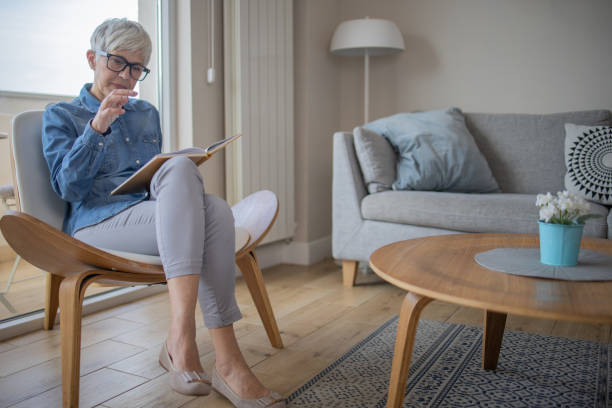istock Woman relaxing and reading a book 1486943739