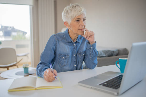 istock Senior woman working from home 1486943870