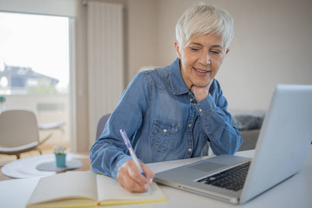 istock Senior woman working from home 1486943880