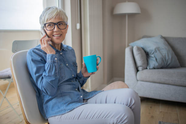 istock Happy senior woman using phone 1486943962