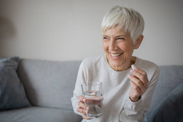 istock Senior woman taking pills 1486943976