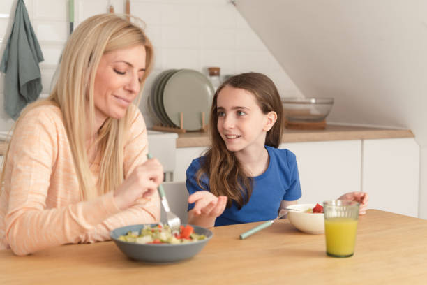 istock Happy mother enjoying in breakfast with her small daughter 1486944217