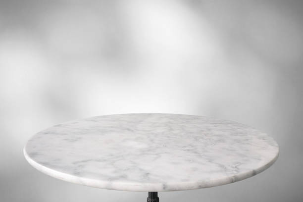istock Marble table with tree shadow drop on white wall background for mockup product display 1486944292